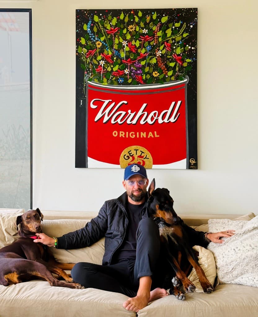 Taylor Good with his Dobermans in front of a WARHODL original painting for the Getty